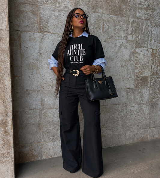 Woman with braids wearing black VOG✦E inspired Rich Auntie Club Members Only tee